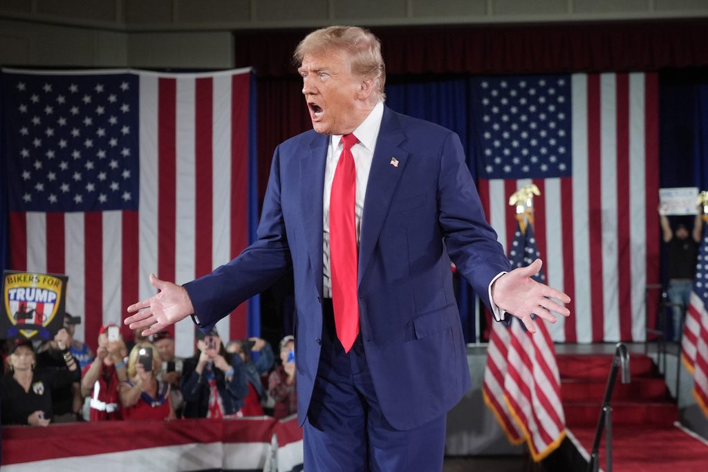 Donald Trump standing on stage at a rally in Waukesha