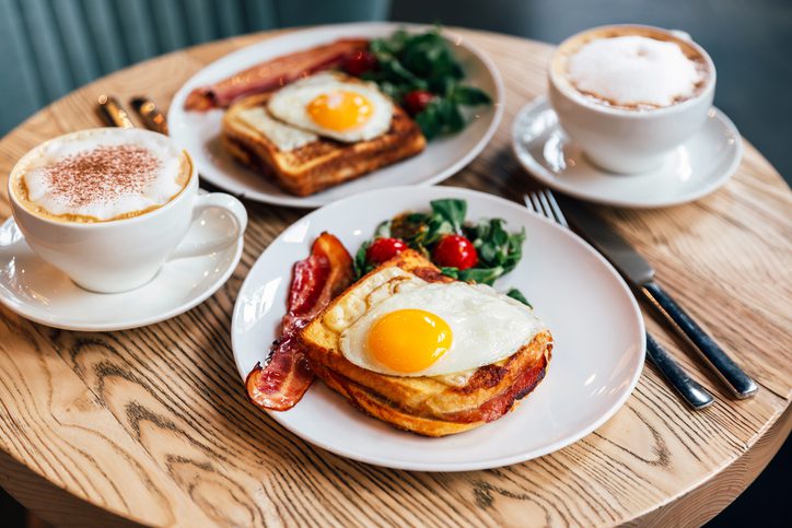 Croque Madame sandwich with bacon served for brunch in a restaurant, side view